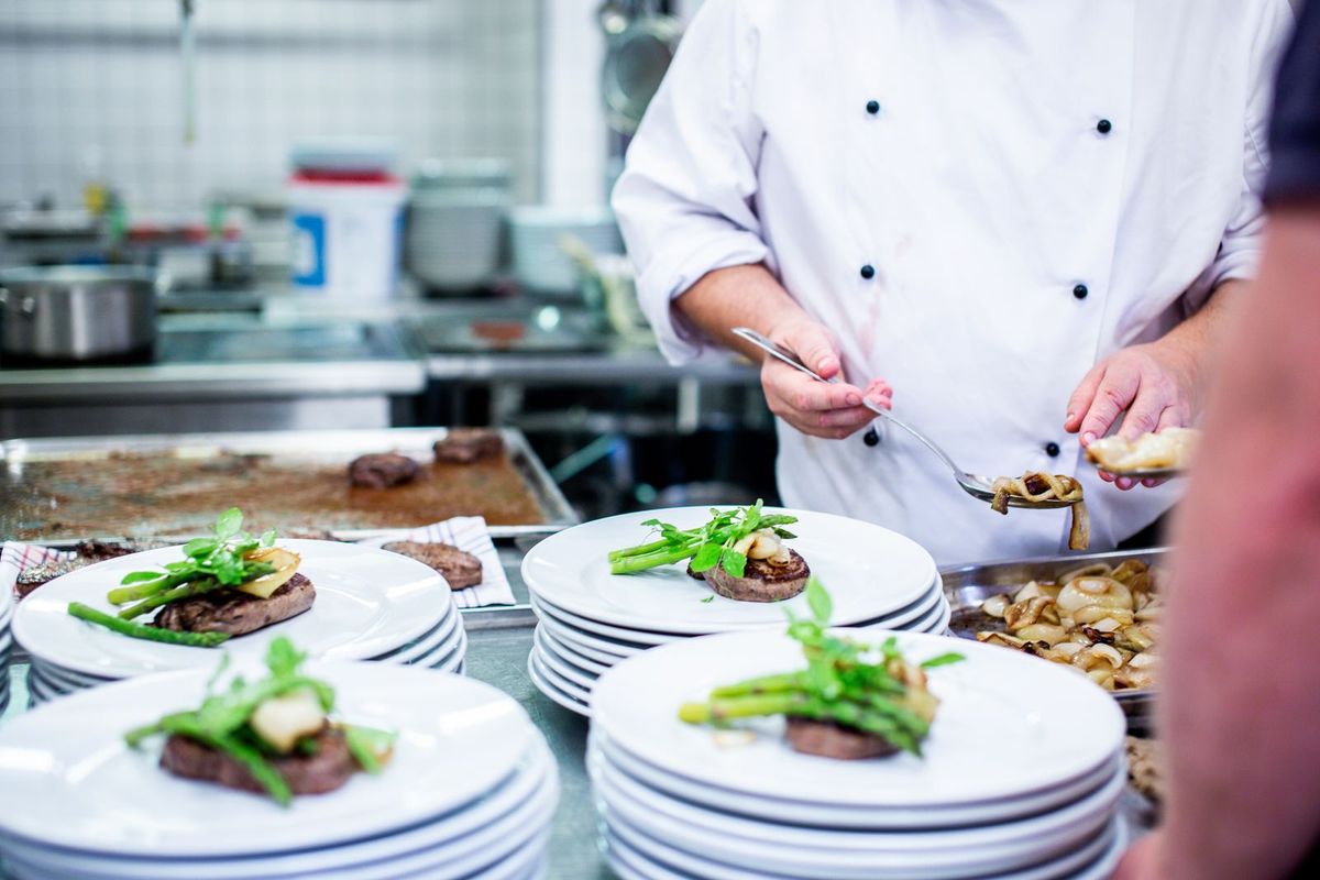 Chef plating dishes in a professional kitchen